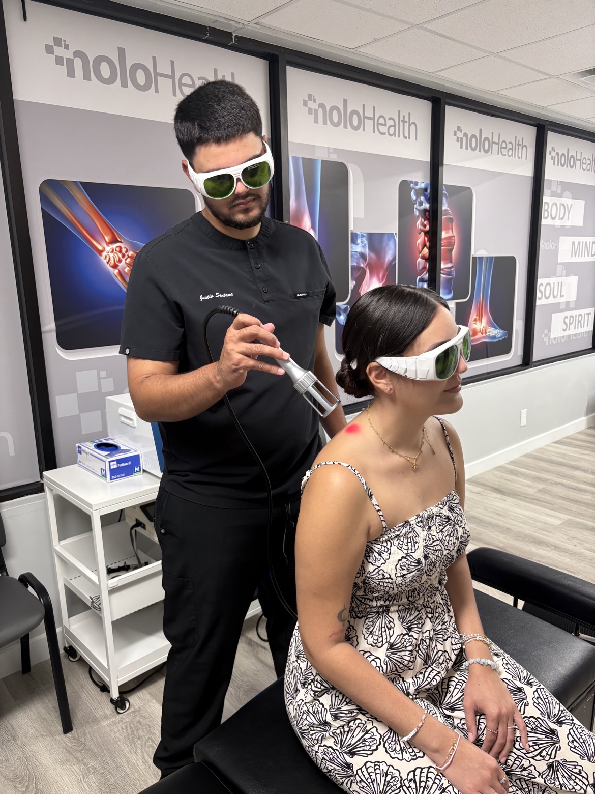 Max Chiropractic clinician providing Class IV laser therapy to a patient's shoulder