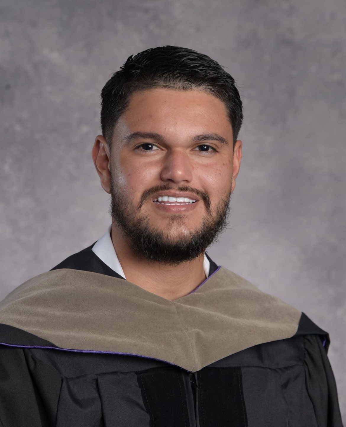 Dr. Justin Santana in his chiropractic graduation gown