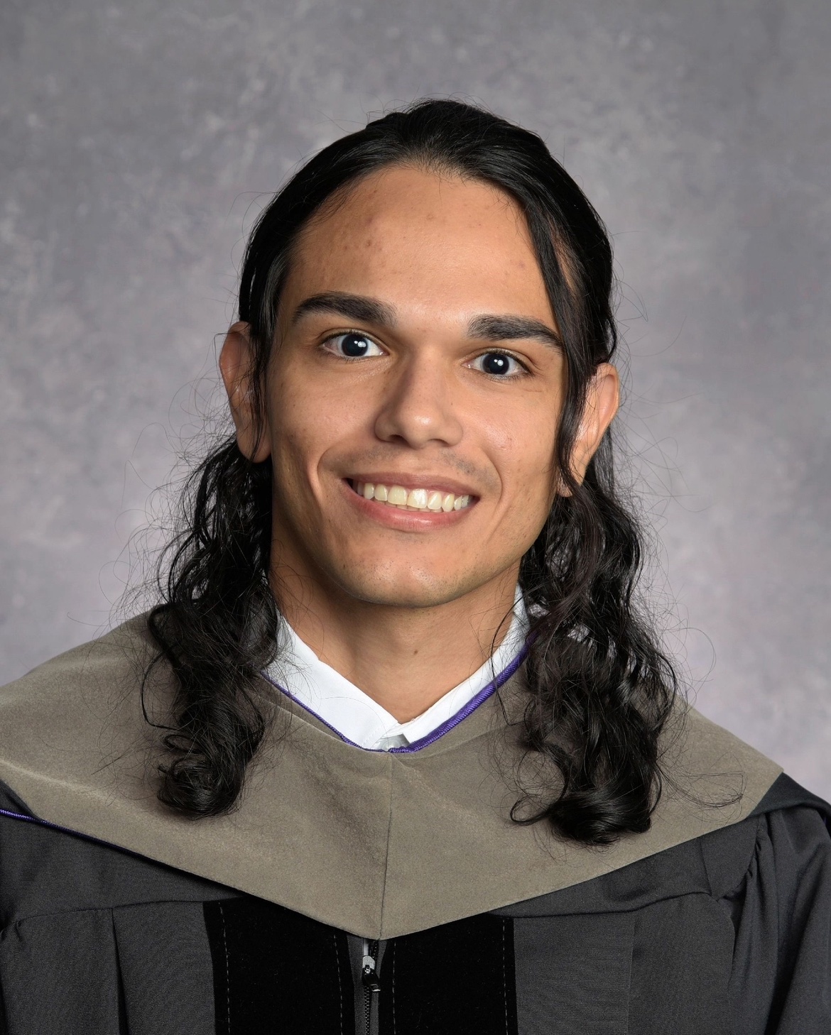 Dr. Max Santana in his Palmer College of Chiropractic graduation gown
